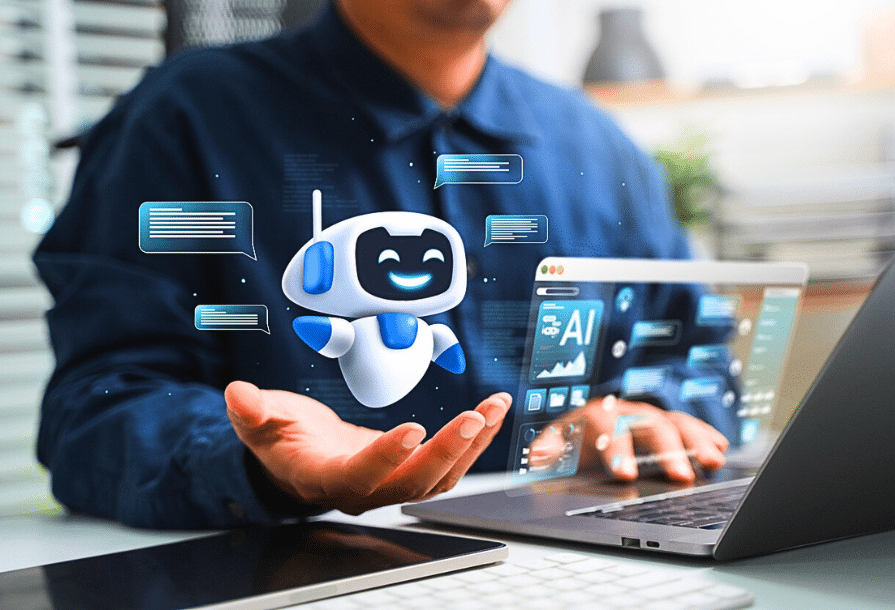 Image d'illustration top 10 meilleurs agents IA. Un homme à son bureau qui travaille sur son ordinateur portable accueille un petit robot amical dans sa main droite.